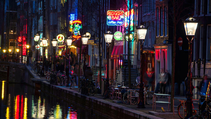Neon signs reflected in Amsterdam canal