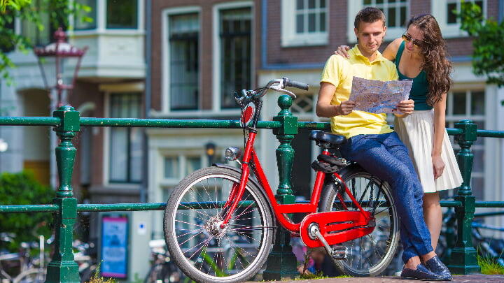 Couple consulting a map by a canal railing