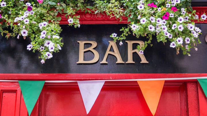 Flowers and flags outside a traditional Dublin pub.