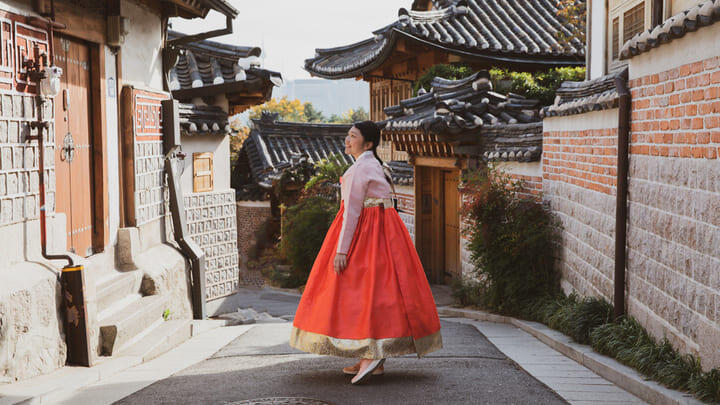 Woman in traditional Korean dress at Bukchon Hanok Village in Seoul.
