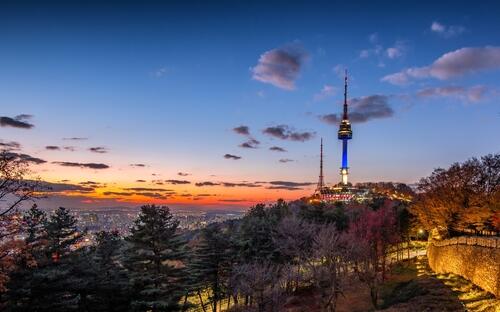 Evening sky in Seoul with a view of the old fortress walls and N Seoul Tower