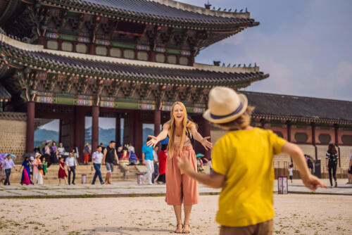 A woman with her child outside a palace in Seoul