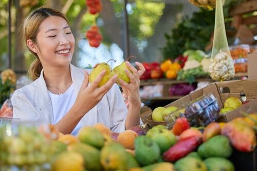 A woman shopping for fruit and vegetable at a market
