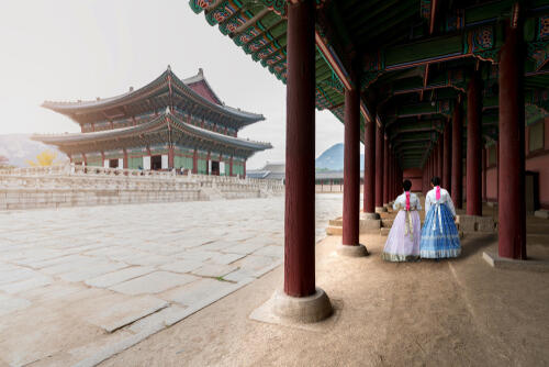 Gyeongbokgung Palace in Seoul, with two women in traditional dress