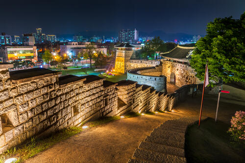 Seoul fortress walls and walking path, lit up at night with city views