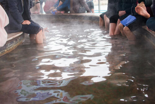 Hot bath in Korea with people dipping their feet in
