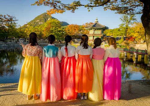 Girls in traditional Korean dress in an autumn garden in Seoul