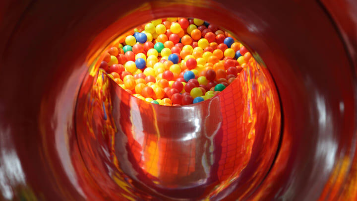 Ball pool at the end of an enclosed slide.