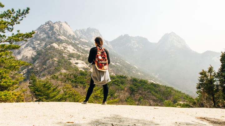 A hiker admiring the view in Bukhansan National Park, Seoul.
