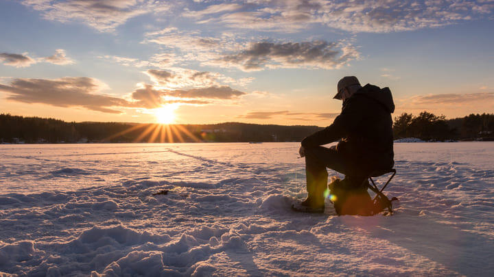 Ice fisherman at sunset.