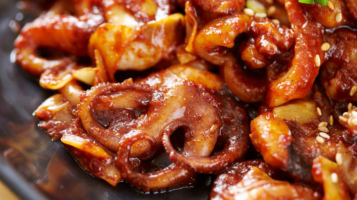 Chargrilled baby octopus marinated in spicy gochujang sauce - a Korean specialty.