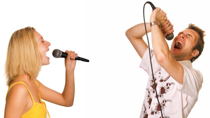 Couple singing karaoke.