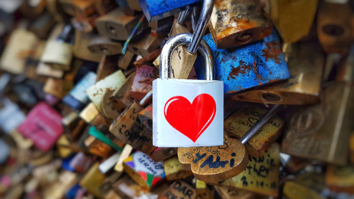 Loveheart padlock attached to a bridge.
