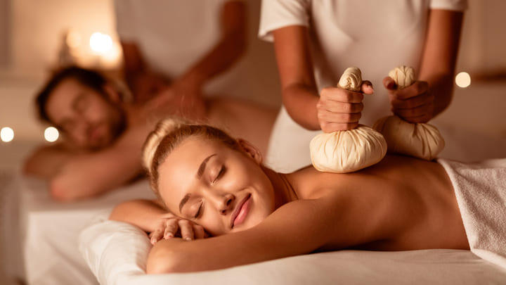 Couple enjoying a massage in a spa.
