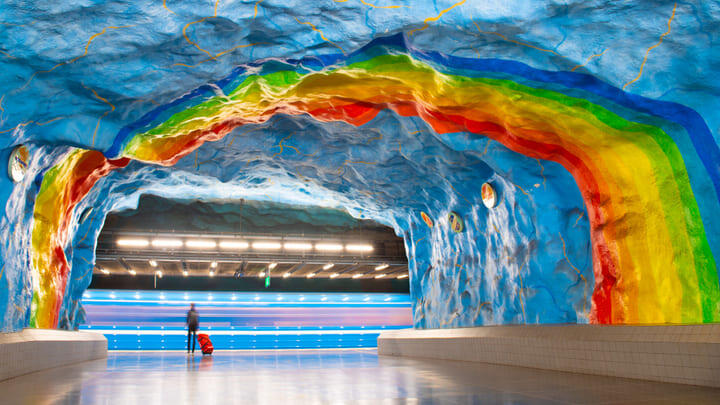 Art depicting rainbows and blue skies on the platform of Stockholm's Stadion metro station