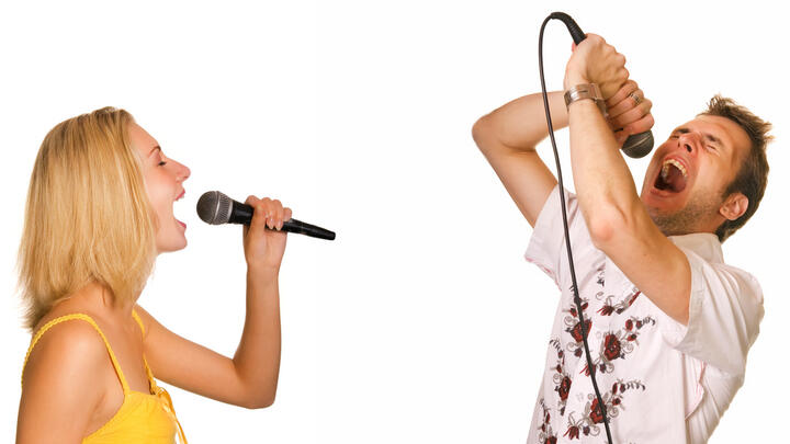 Young couple singing karaoke