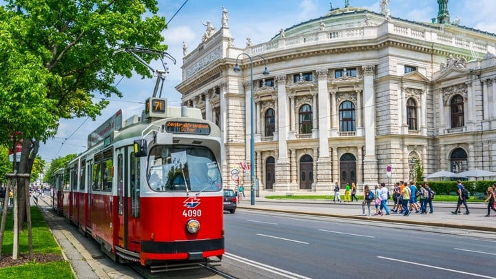 Red tram passing by the Burgtheater on Vienna's famous Ringstrasse.