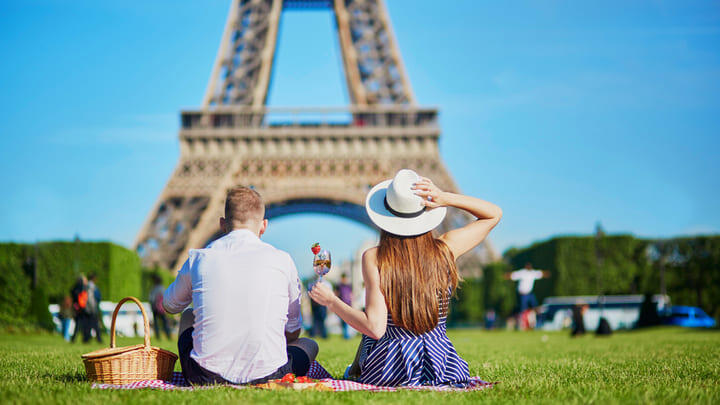 Couple picnicking by the Eiffel Tower in Paris