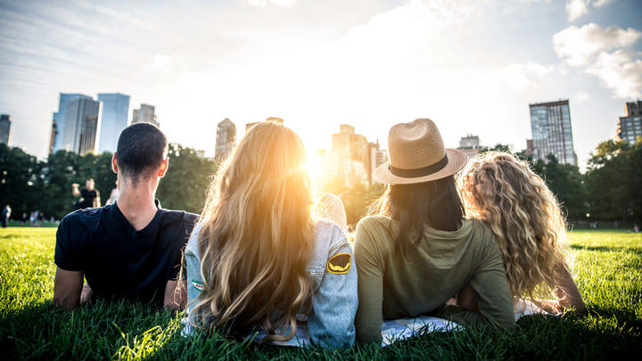 Friends in Central Park, New York, at sunset.