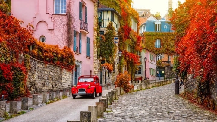 A colorful cobbled street in Paris's Montmartre district.