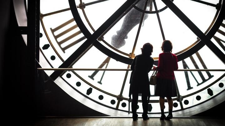 Tourists behind the station clock at the Musée d'Orsay in Paris.