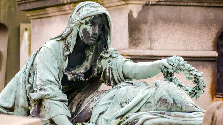 Decorative statue on a tomb in Pere Lachaise Cemetery, Paris.