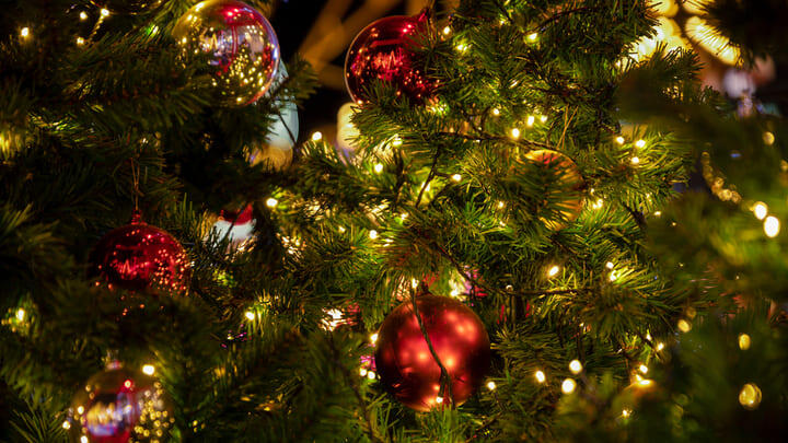 Close up image of a Christmas tree's baubles and fairy lights