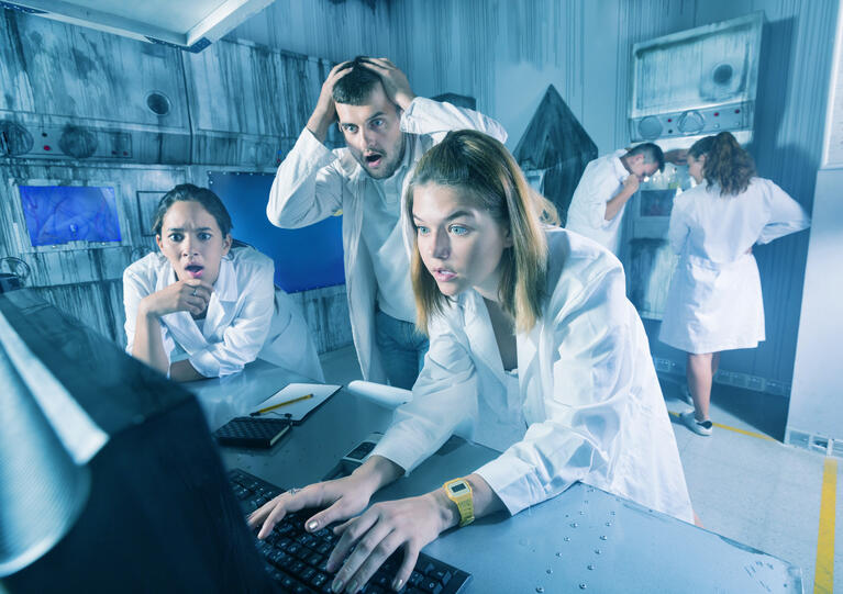 Teens solving clues in an escape room