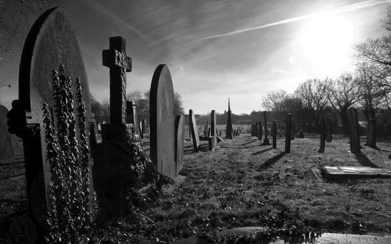 The sun sets over a graveyard