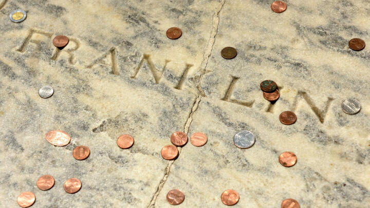 Benjamin Franklin's grave covered in pennies, one of the best outdoor activities in Philadelphia