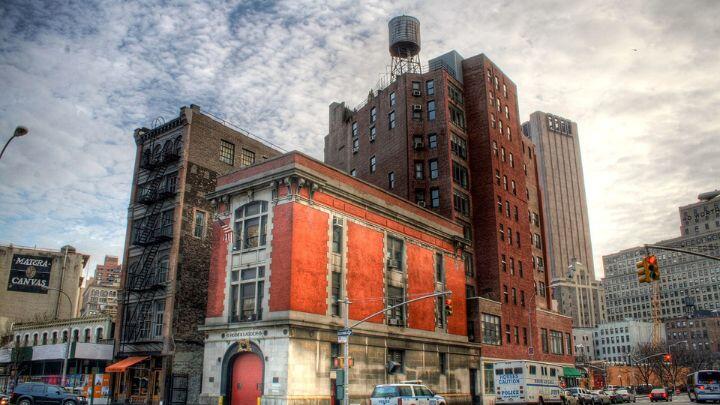 Firehouse that featured in the Ghostbusters movie, a three storey brick building, with red painted fire doors