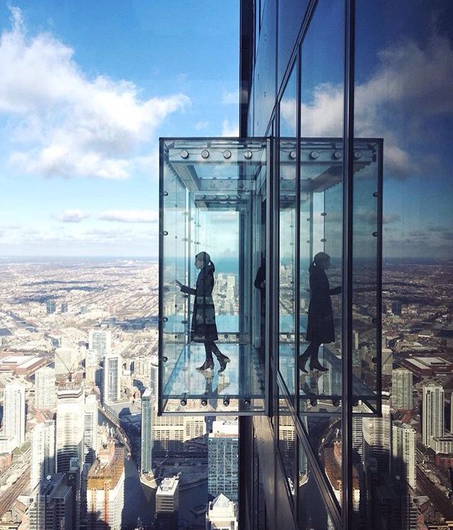A woman on the Ledge at Skydeck Chicago.