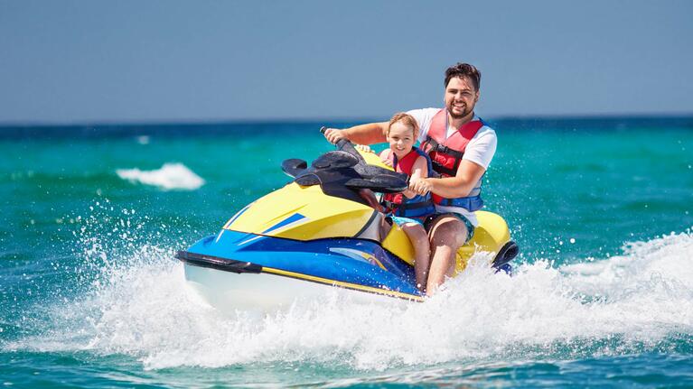 An adult and child enjoy jet ski rental