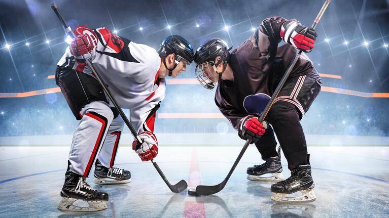 Ice hockey players face off against each other