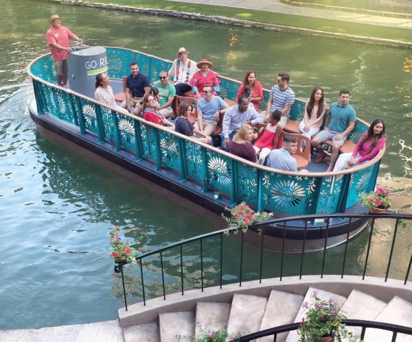 A small river boat with tourists.