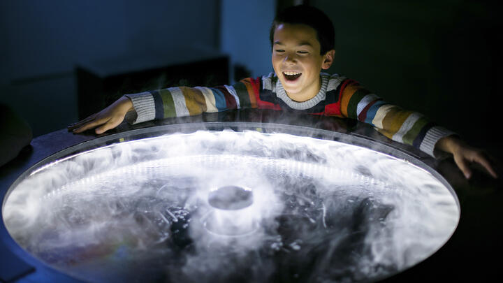 A child enjoying one of the exhibits at the Exploratorium, San Francisco