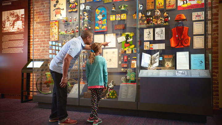 Family exploring a Mickey Mouse exhibit at the Walt Disney Family Museum, San Francisco