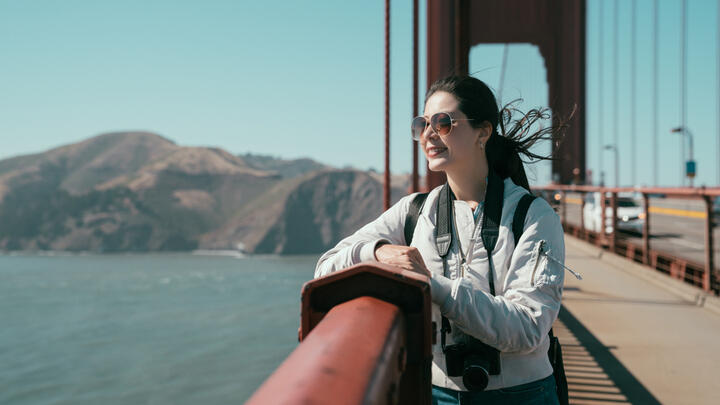Woman taking a break to admire the view during a walk across the Golden Gate Bridge in San Francisco