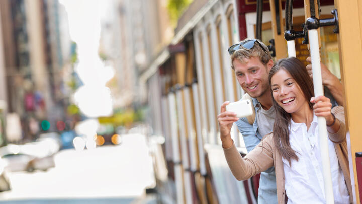 Couple taking a selfie from San Francisco tram