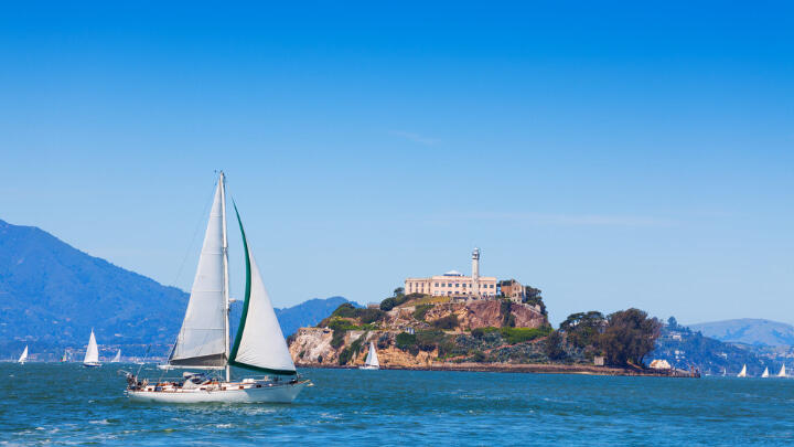 Sailboat passing by Alcatraz Island