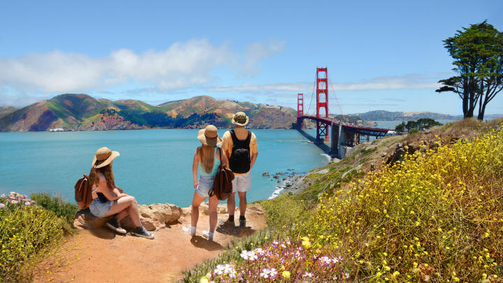 Three tourists admiring the Golden Gate Bridge