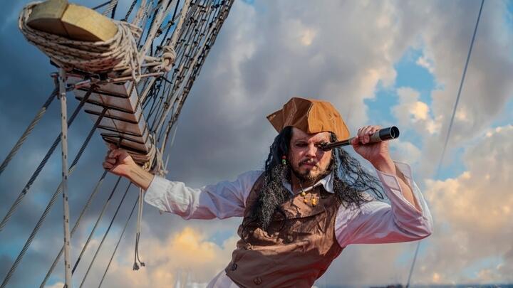 Man dressed as a pirate aboard a ship
