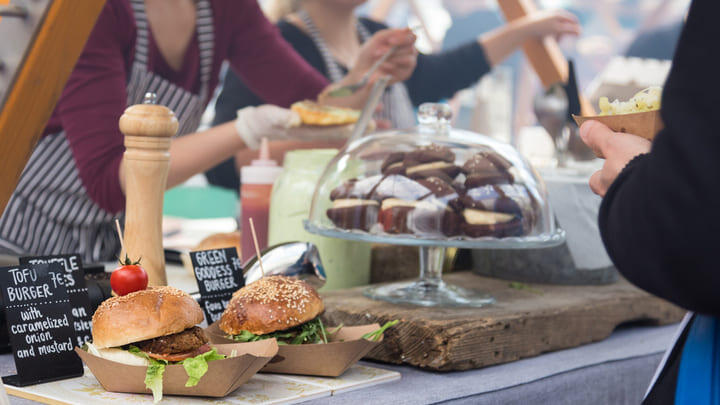 A vegan food stall serving up burgers and cakes