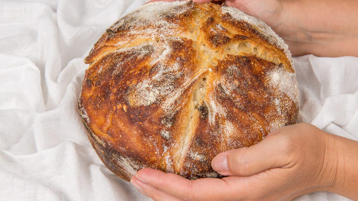 A freshly baked loaf of crusty sourdough bread