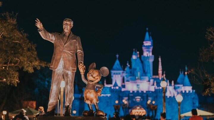 Statue of Walt Disney and Mickey Mouse in front of the Sleeping Beauty Castle in Disneyland, LA.