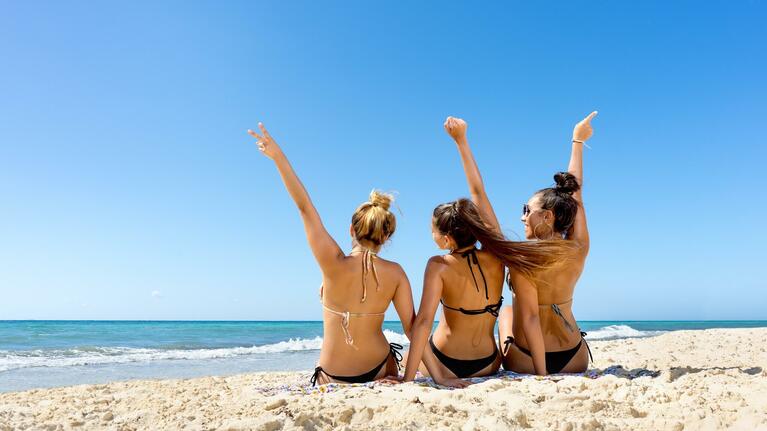 Girls enjoy the sands of Cancun