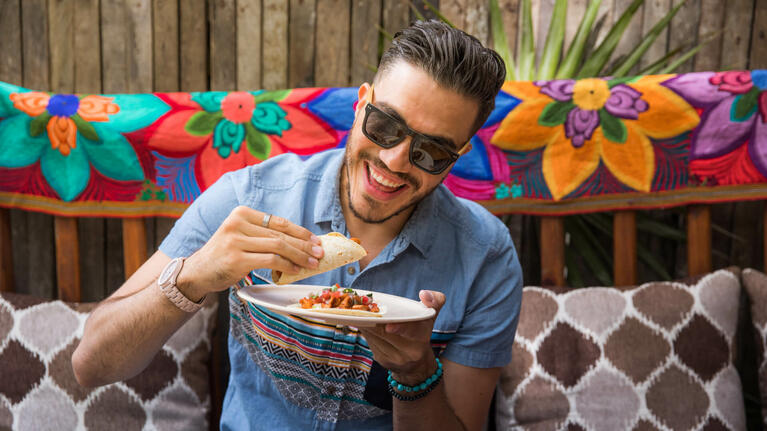 Visitors sample the local food in Cancun