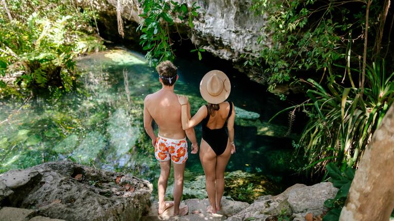 A couple admire the waters of a Cancun cenote