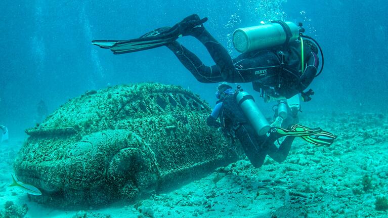 Scuba divers exploring the Underwater Museum Cancun