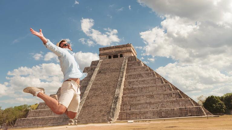 Man jumping in front of Chichen Itza's El Castillo pyramid